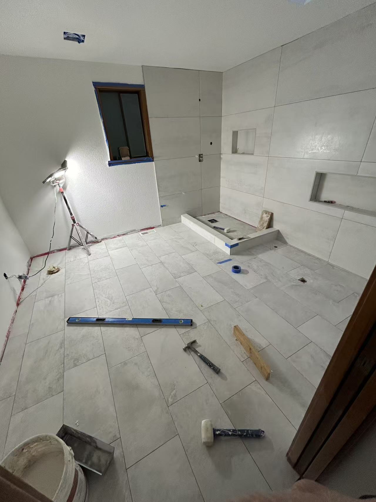 Bellevue spa bath stage 5 — large-format porcelain tile install